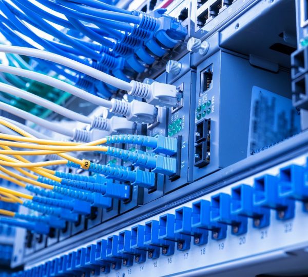 Fiber Optic cables connected to an optic ports and Network cables connected to ethernet ports