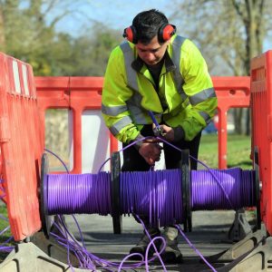 cityfibre engineer over reel of purple fibre