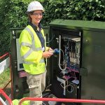 female openreach engineer at an fttc cabinet
