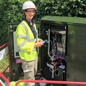 female openreach engineer at an fttc cabinet
