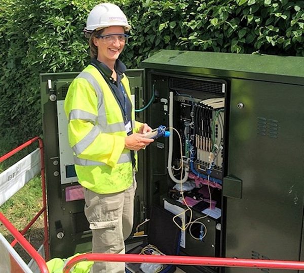 female openreach engineer at an fttc cabinet