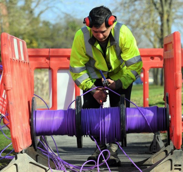 cityfibre engineer over reel of purple fibre