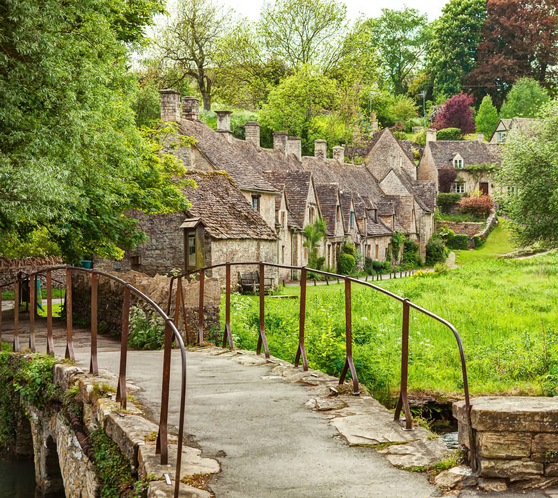 Old footbridge and  traditional Cotswold cottages,   Bibury,  England, UK.