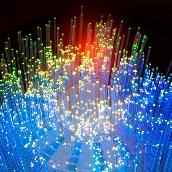 Fiber optics network cable on technology background