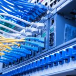 Fiber Optic cables connected to an optic ports and Network cables connected to ethernet ports