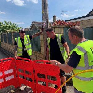 Lit Fibre Engineers Working Near Pavement Chamber