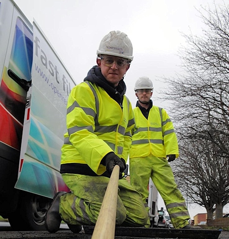 openreach engineer pulling fibre optic cable duct