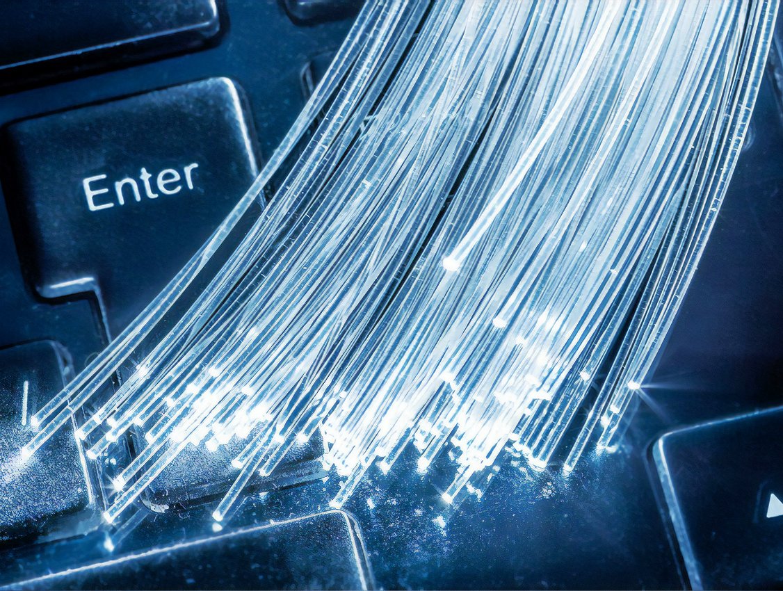 Bundles of optical fibers with lights at the ends lie on the keyboard.
