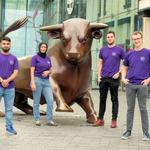 BT UK Staff Standing Next to Bull