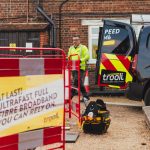 Trooli engineer next to van