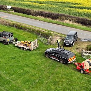 Alncom Engineers and Vehicles in Field