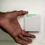 CommunityFibre-Engineer-Holding-ONT-Close-up-2024