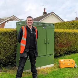 Fusion Fibre Group Engineer Mike Loten next to full fibre cabinet