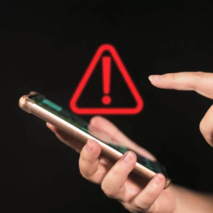Mobile phone held by hands with complaint warning sign 123RF 210437881 on 040624
