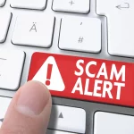 Scam Alert UK Finger on Computer Keyboard Warning