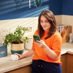 KCOM-eero-6-device-with-user-in-kitchen-PR-061124