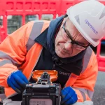 Openreach 2025 engineer looking sideways at a fibre splicer