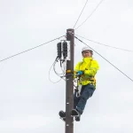 2025-Openreach-female-engineer-at-work-up-telecoms-pole