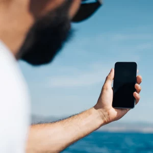 Mobile user near the sea by 123rf ID46966156