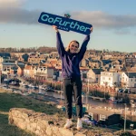 GoFurther Fund woman holding placard
