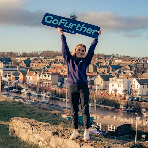 GoFurther Fund woman holding placard