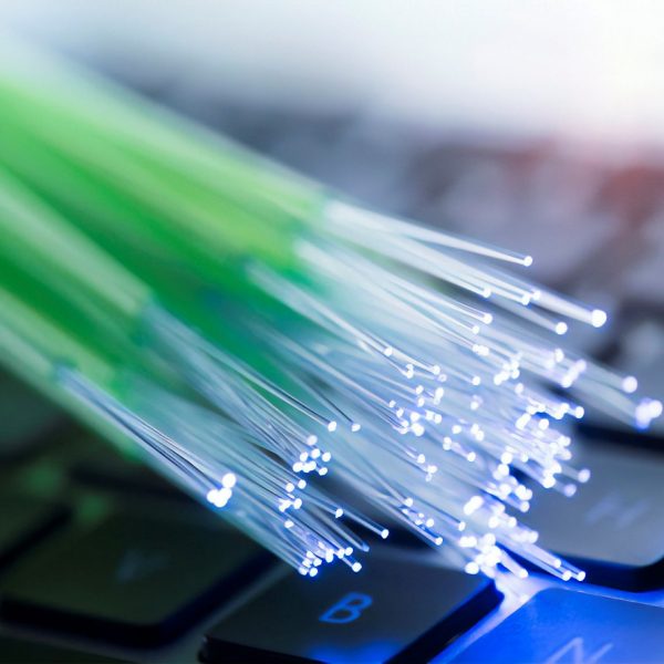 network cables and fiber optic closeup with keyboard background
