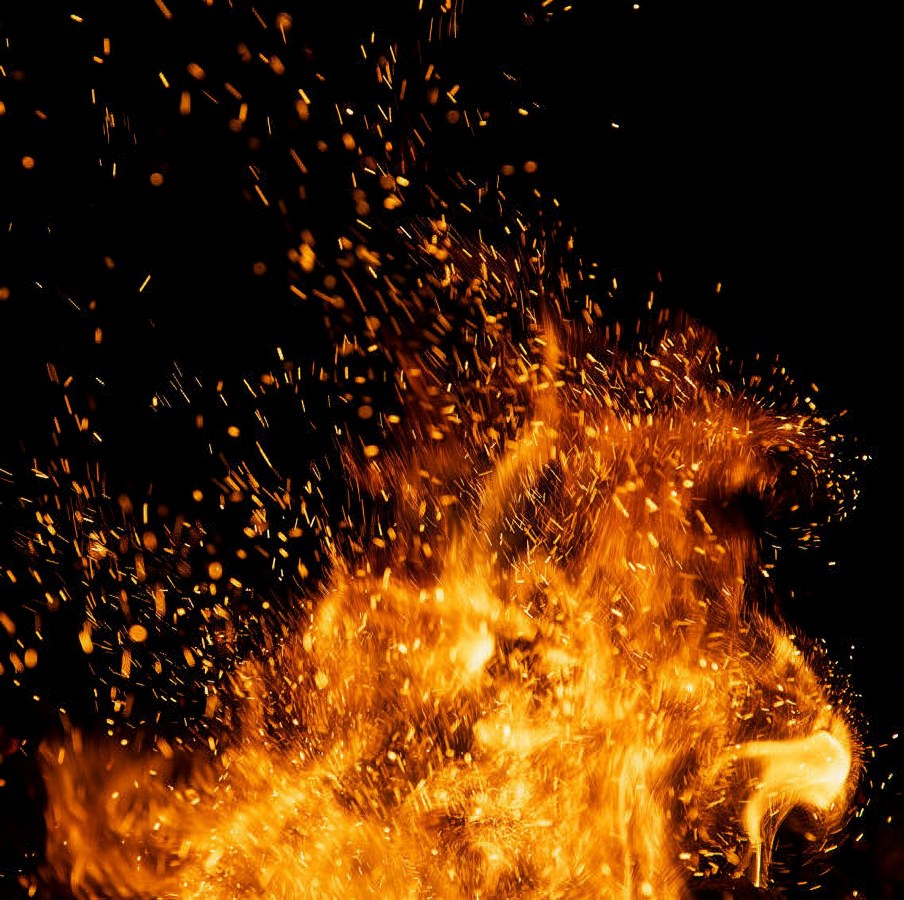 Fire sparks particles with flames isolated on black background.