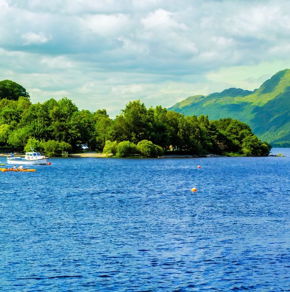 People  on the motor boat at the Loch Lomond lake in Scotland