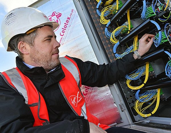 virgin media engineer touching fibre optic wires