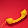 Analogue-uk-phone-handset-on-red-background 123rf