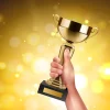 Gold Award Trophy Held in Hand 123RF - 166249402